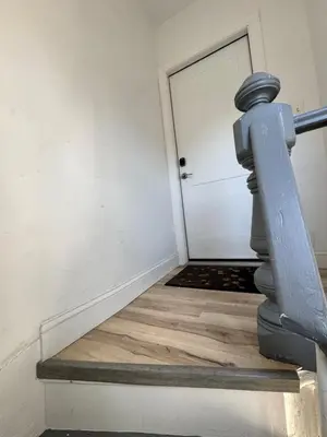 a staircase leading to a door in a room at Luxury Modern Apt near NYC for 4 people in Jersey City