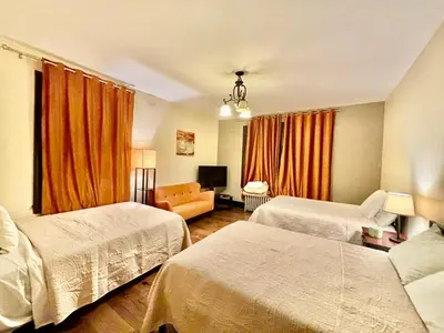 a hotel room with two beds and a couch at MOTEL House in Newark