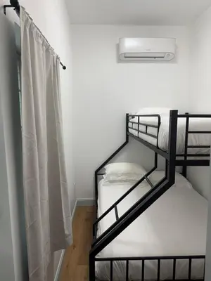 two bunk beds in a room with a curtain at Cozy Stay Near Fishtown - Close to Subway & Center City by Globenest in Philadelphia