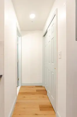 an empty hallway with white walls and wood floors at Cozy Stay Near Fishtown - Close to Subway & Center City by Globenest in Philadelphia