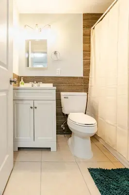 a bathroom with a toilet and a sink and a mirror at Cozy Stay Near Fishtown - Close to Subway & Center City by Globenest in Philadelphia