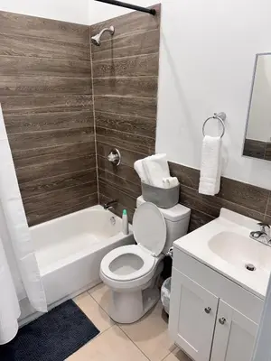 a bathroom with a toilet and a tub and a sink at Cozy Stay Near Fishtown - Close to Subway & Center City by Globenest in Philadelphia