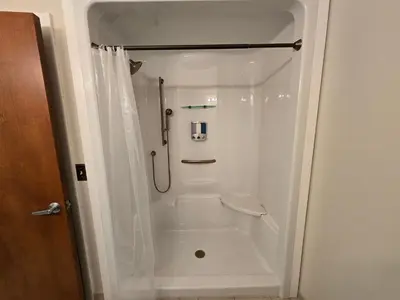 a white shower in a bathroom with a toilet at Spooky Nook Bed and Breakfast in Manheim