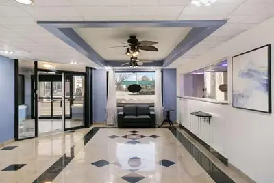 a living room with a ceiling fan and a couch at Dutchland Motel in Lancaster