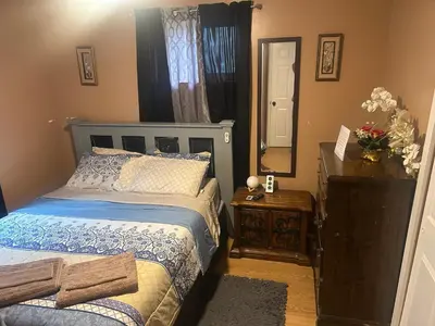 a bedroom with a bed and a dresser and a mirror at Hidden Gem in Middletown