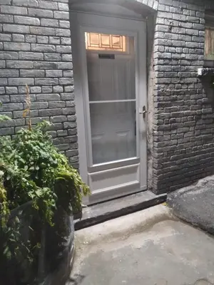 a door in a brick building with a plant at Hidden Gem in Middletown