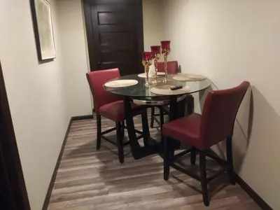 a dining room with a glass table and red chairs at Hidden Gem in Middletown
