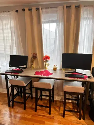 a wooden table with two computers on top of it at 18stStays in Philadelphia