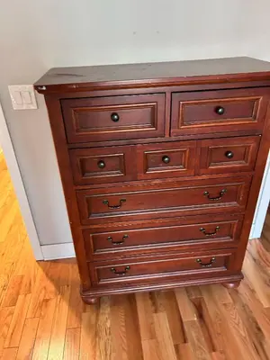 a wooden dresser in the corner of a room at 18stStays in Philadelphia