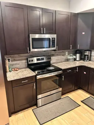 a kitchen with stainless steel appliances and a microwave at 18stStays in Philadelphia
