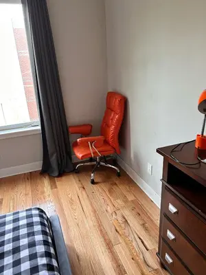 a red chair sitting in a room with a window at 18stStays in Philadelphia