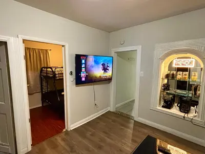 a living room with a flat screen tv on a wall at Cozy Cafe, Walk to The Mall, 30min to NYC & 5min to EWR in Elizabeth
