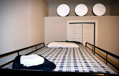 a bedroom with two beds and two mirrors on the wall at Cozy Cafe, Walk to The Mall, 30min to NYC & 5min to EWR in Elizabeth