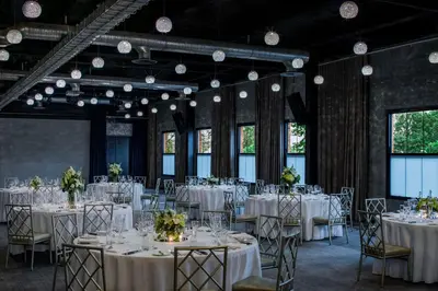 a room filled with tables and chairs with white table settings at Hotel Nyack, a JdV by Hyatt Hotel in Nyack