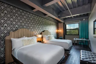 a hotel room with two beds and a desk at Hotel Nyack, a JdV by Hyatt Hotel in Nyack