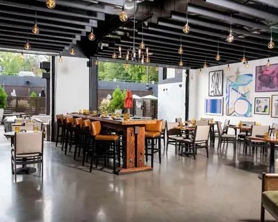 a dining room with a large table and chairs at Hotel Nyack, a JdV by Hyatt Hotel in Nyack