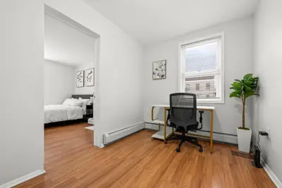 an office with a desk and a chair in a room at Spacious 3-Bedroom Apartment near NYC - 15min to Times Square, Empire State Building, Central Park, Statue of Liberty in Jersey City