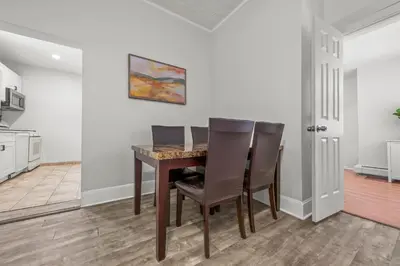 a dining room with a table and chairs at Spacious 3-Bedroom Apartment near NYC - 15min to Times Square, Empire State Building, Central Park, Statue of Liberty in Jersey City