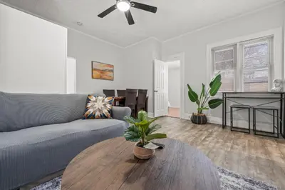 a living room with a couch and a table at Spacious 3-Bedroom Apartment near NYC - 15min to Times Square, Empire State Building, Central Park, Statue of Liberty in Jersey City