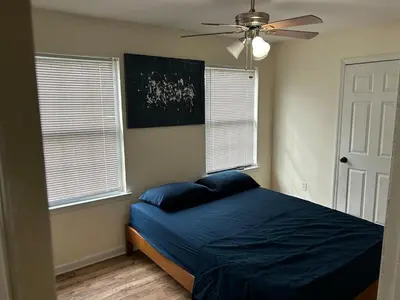 a bedroom with a bed and a ceiling fan at Luxury Townhouse in Newark in Newark