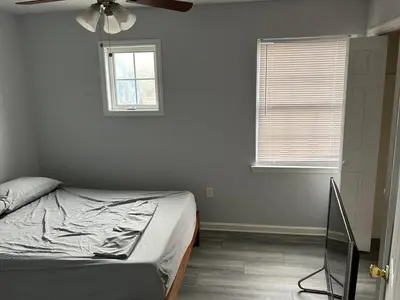 a bedroom with a bed and a ceiling fan at Luxury Townhouse in Newark in Newark