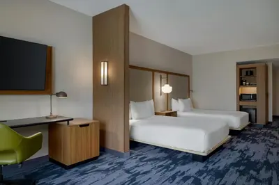 a hotel room with two beds and a flat screen tv at Fairfield by Marriott Inn & Suites Lancaster in Lancaster