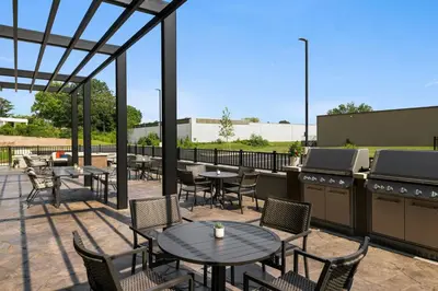 a patio with tables and chairs and a grill at Fairfield by Marriott Inn & Suites Lancaster in Lancaster