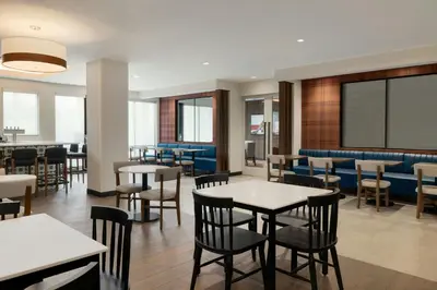 a restaurant with tables and chairs and a chalkboard at Fairfield by Marriott Inn & Suites Lancaster in Lancaster