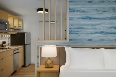 a bedroom with a bed and a table with a lamp at TownePlace Suites by Marriott Lancaster in Lancaster