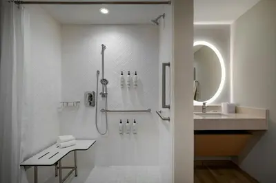 a white bathroom with a shower and a sink at TownePlace Suites by Marriott Lancaster in Lancaster