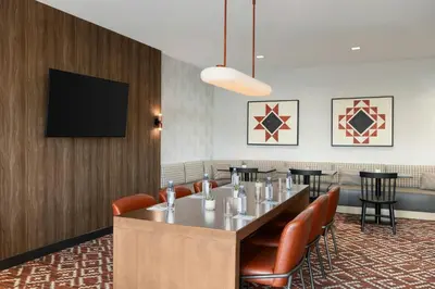 a dining room with a table and chairs and a flat screen tv at TownePlace Suites by Marriott Lancaster in Lancaster