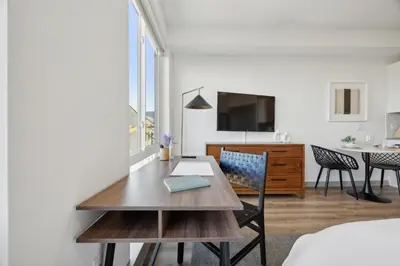 a living room with a table and a dining room at The Commons on Ludlow in Philadelphia