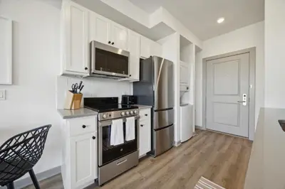 a kitchen with white cabinets and a stove top oven at The Commons on Ludlow in Philadelphia