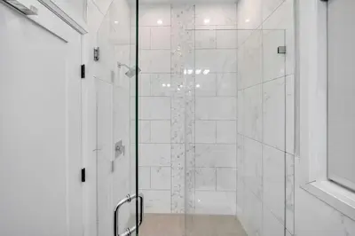 a shower with a glass door in a bathroom at Modern Luxury 3BR 2BA 10 minutes to NYC in Weehawken