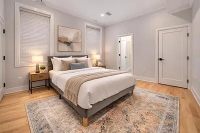 a bedroom with a large bed and a rug at Modern Luxury 3BR 2BA 10 minutes to NYC in Weehawken