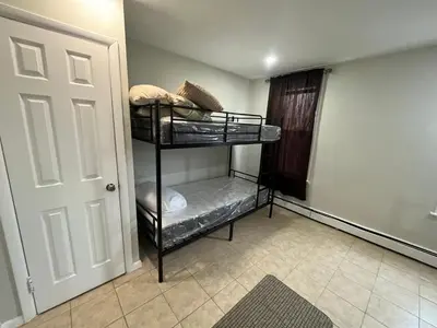 a room with two bunk beds in a room at Modern Oasis in Bayonne
