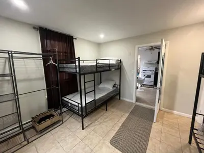 a bedroom with two bunk beds in a room at Modern Oasis in Bayonne