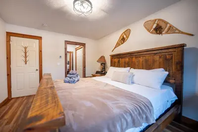 a bedroom with a large bed with a wooden headboard at Luxury House in Pocono Mountains in Tannersville