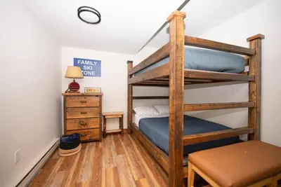 a bedroom with two bunk beds and a desk at Luxury House in Pocono Mountains in Tannersville
