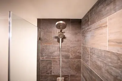 a shower with a shower head in a bathroom at Luxury House in Pocono Mountains in Tannersville