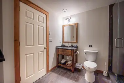 a bathroom with a toilet and a mirror at Luxury House in Pocono Mountains in Tannersville