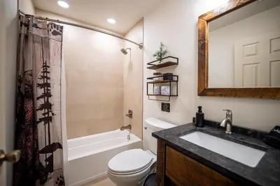 a bathroom with a sink and a toilet and a tub at Luxury House in Pocono Mountains in Tannersville