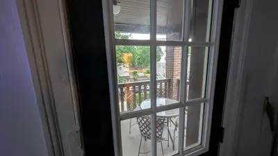 an open window with a view of a balcony at Rooftop GreeneHouse Suite in Philadelphia