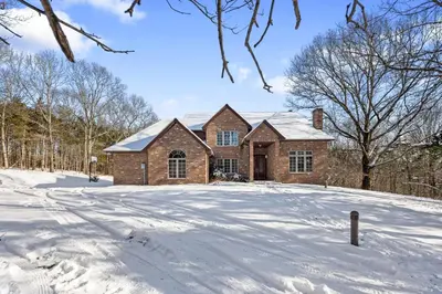 a brick house in the snow at Secluded 9BR Getaway, Pool, Hot Tub & Huge Deck in Chester