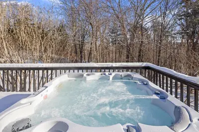a hot tub on a deck covered in snow at Secluded 9BR Getaway, Pool, Hot Tub & Huge Deck in Chester