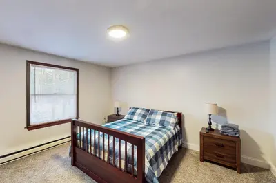 a bedroom with a bed and a window at Hot Tub, Dock, Pool Table! Lakefront Poconos Haven in White Haven