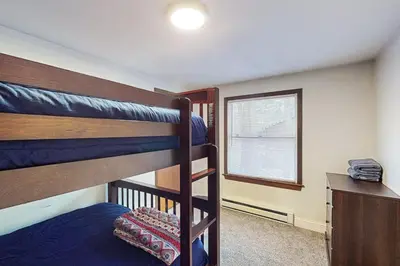 a bedroom with two bunk beds and a window at Hot Tub, Dock, Pool Table! Lakefront Poconos Haven in White Haven