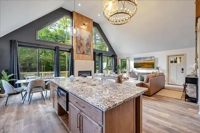 a kitchen and living room with a large island at Luxury Hot Tub Sauna Game Room Dog Friendly in Albrightsville