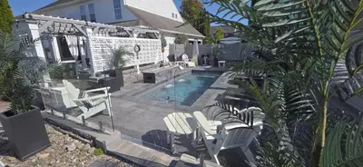 a backyard with a pool and chairs and a house at Staycation Oasis! a unique Experience! Heated pool open until November 1st in Easton