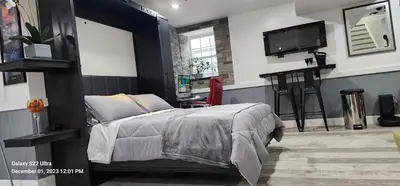a bedroom with a bed and a desk and a tv at Staycation Oasis! a unique Experience! Heated pool open until November 1st in Easton